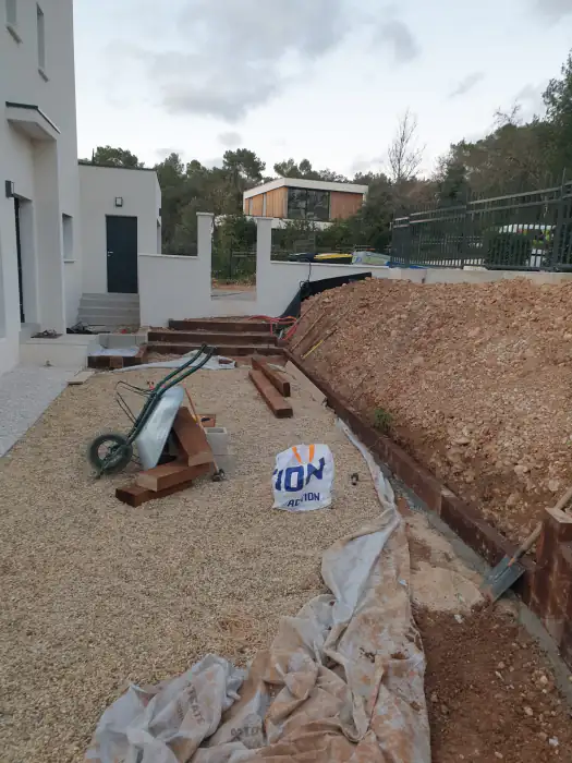 Chantier en cours : gravier stabilisé, talus de terre et bordures posées